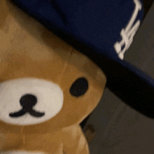 a teddy bear wearing a blue la hat