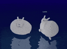 a couple of stuffed animals are standing next to each other on a blue surface .