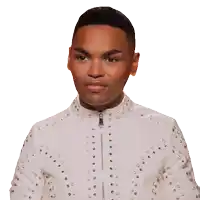 a young man wearing a white jacket with silver studs on it