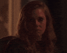 a close up of a woman 's face with long hair