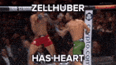 two men are fighting in a boxing ring and one of them has the word heart on his shorts