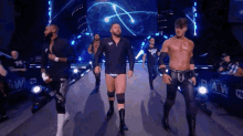 a group of wrestlers are walking down a ramp in front of a large screen that says wwf