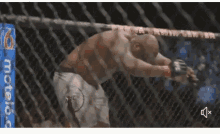 a man is laying on the ground in a boxing ring .