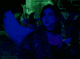 a woman with angel wings and a choker is standing in a dark room