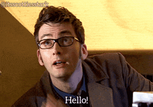 a man wearing glasses says hello in a gif