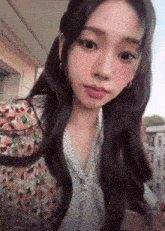 a close up of a woman taking a selfie with her eyes closed