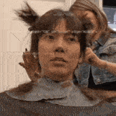 a woman is getting her hair cut by a hairdresser with the url right 720 id script align middle visible