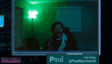 a screen shows a man in a room with the name paul on it