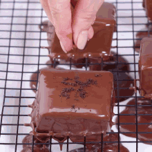 a person is dipping a piece of chocolate into a sauce