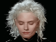 a close up of a woman 's face with white hair