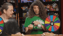a man wearing a green shirt with the word stegosaur on it is playing a game