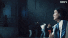 a man in a blue jacket is being kicked in the face by another man with the word genv on the bottom