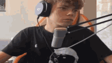 a young man is wearing headphones and a microphone .