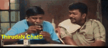 two men sitting at a table with thiruda n chat written on the bottom right