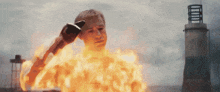 a man with a glove on his head is on fire