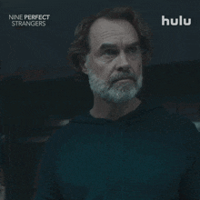 an advertisement for nine perfect strangers shows a man with a beard saying " what "