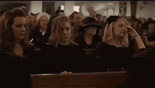 a large group of people are sitting in a church .