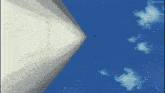 a blue sky with white clouds and a white pyramid in the middle