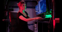 a woman sitting in front of a computer with the word yummy written on the screen