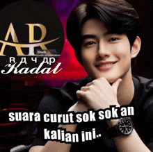 a young man with a watch on his wrist is smiling in front of a sign that says suara curut sok sok an kalian ini
