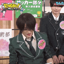 a man in a green jacket has a name tag that says ringaku