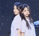 two girls standing back to back with bubbles behind them