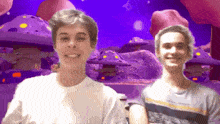 two young men are standing in front of a purple background with mushrooms
