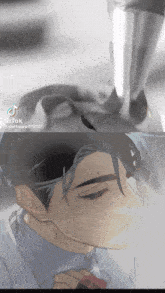 a man in a suit and tie is looking down with a tear coming out of his eye
