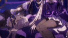 a man and a woman are sitting on a couch in a purple room .