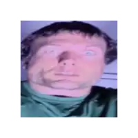 a close up of a man 's face with a green shirt on making a funny face .