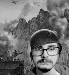 a man wearing glasses and a helmet stands in front of a battle scene