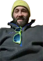 a man with a beard wearing a grey jacket and a yellow hat