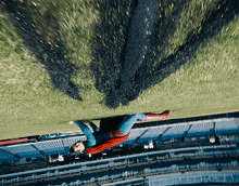 a man in a superman costume is upside down in the air