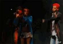 a man with red hair is standing next to a woman singing