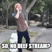 a man is talking on a cell phone while standing on the side of the road .