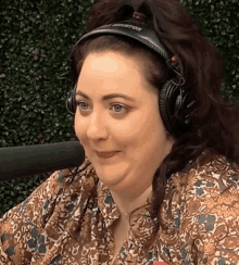 a woman wearing a pair of headphones that say sony on them
