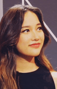 a close up of a woman 's face with a black shirt on