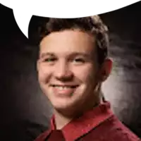 a young man in a red shirt with a speech bubble behind him