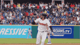 a baseball player wearing a jersey that says guardians is running towards home plate