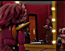 a red toy is standing in front of a mirror with lights on it