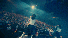 a girl in a sailor uniform is standing in front of a crowd