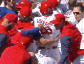 a group of baseball players are gathered around a player wearing a jersey with the number 7 on it