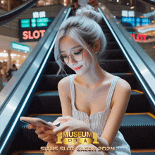 a woman is sitting on an escalator looking at her cell phone