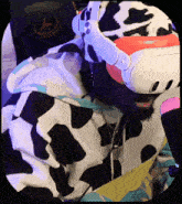 a man in a cow print hoodie is wearing a virtual reality headset .