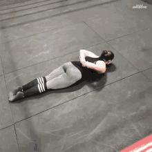 a woman is doing a split on a tiled floor with awesome written on the bottom