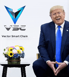 a man in a suit and tie sits in front of a sign that says ' vsc vector smart chain '