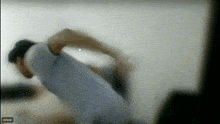 a blurry picture of a man 's back with a watermark that says ' zoom ' on the bottom right
