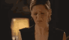 a woman sticking her tongue out in a dark room