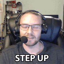 a man wearing headphones and a microphone with the words step up below him