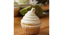 a close up of a cupcake with white frosting